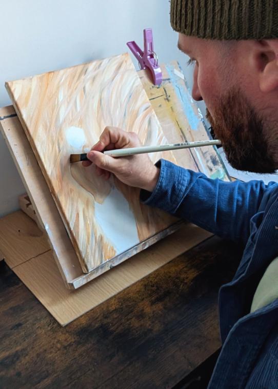 Bradley working on a painting in the studio