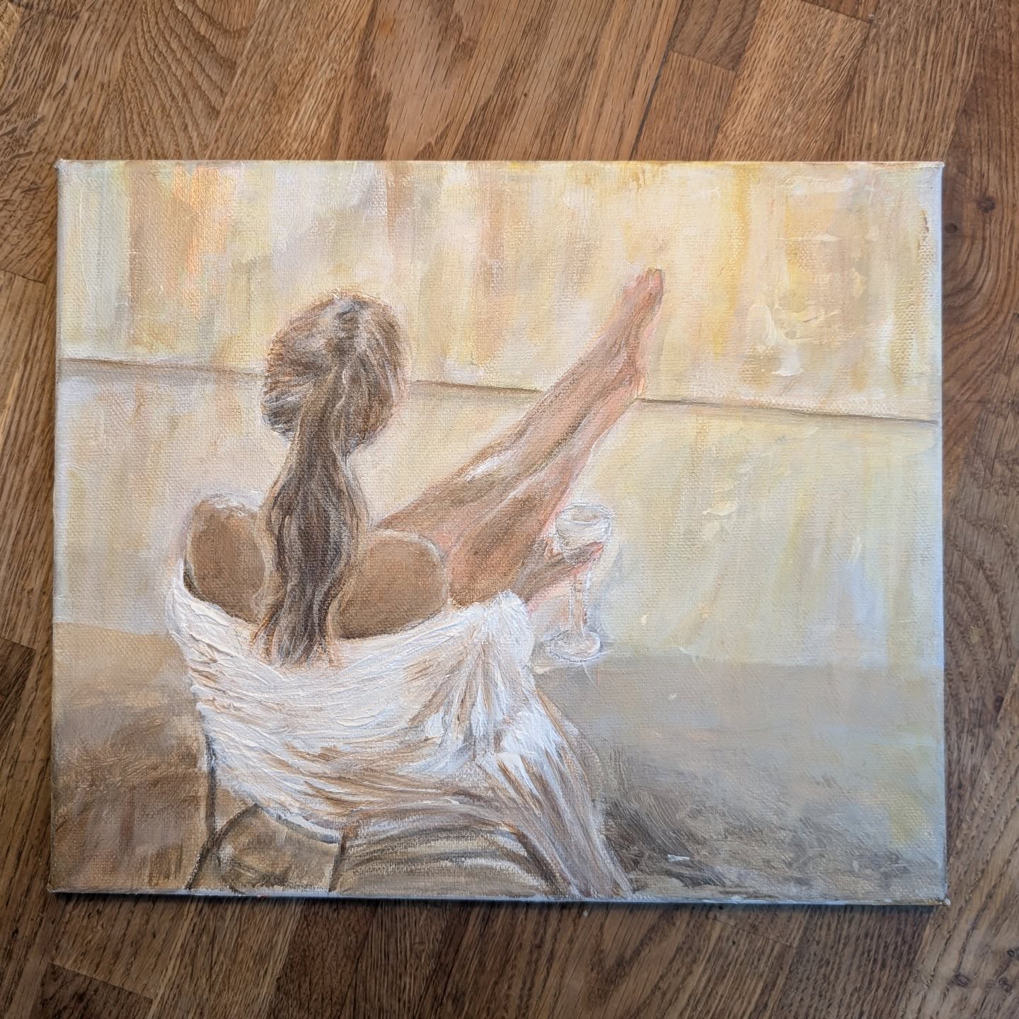 Painting of a woman relaxing with her feet up and a glass of wine